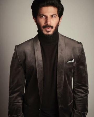 Dulquer Salman arrived for the promotions of The Zoya Factor recently in a charcoal grey jacket and matching trousers by Kunal Anil Tanna - Fashion Models